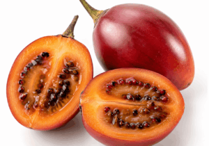 Red tamarillo fruit shown whole and sliced with orange flesh and dark seeds