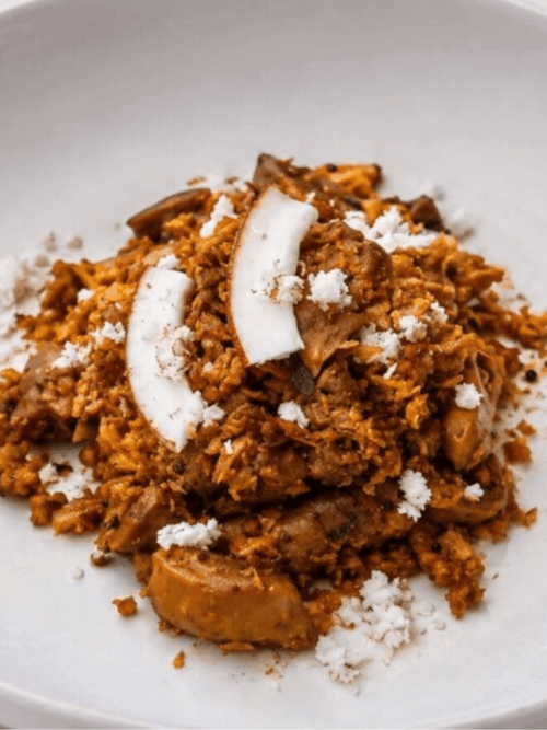 Kerala chicken gizzard thoran with grated coconut and fresh coconut slices