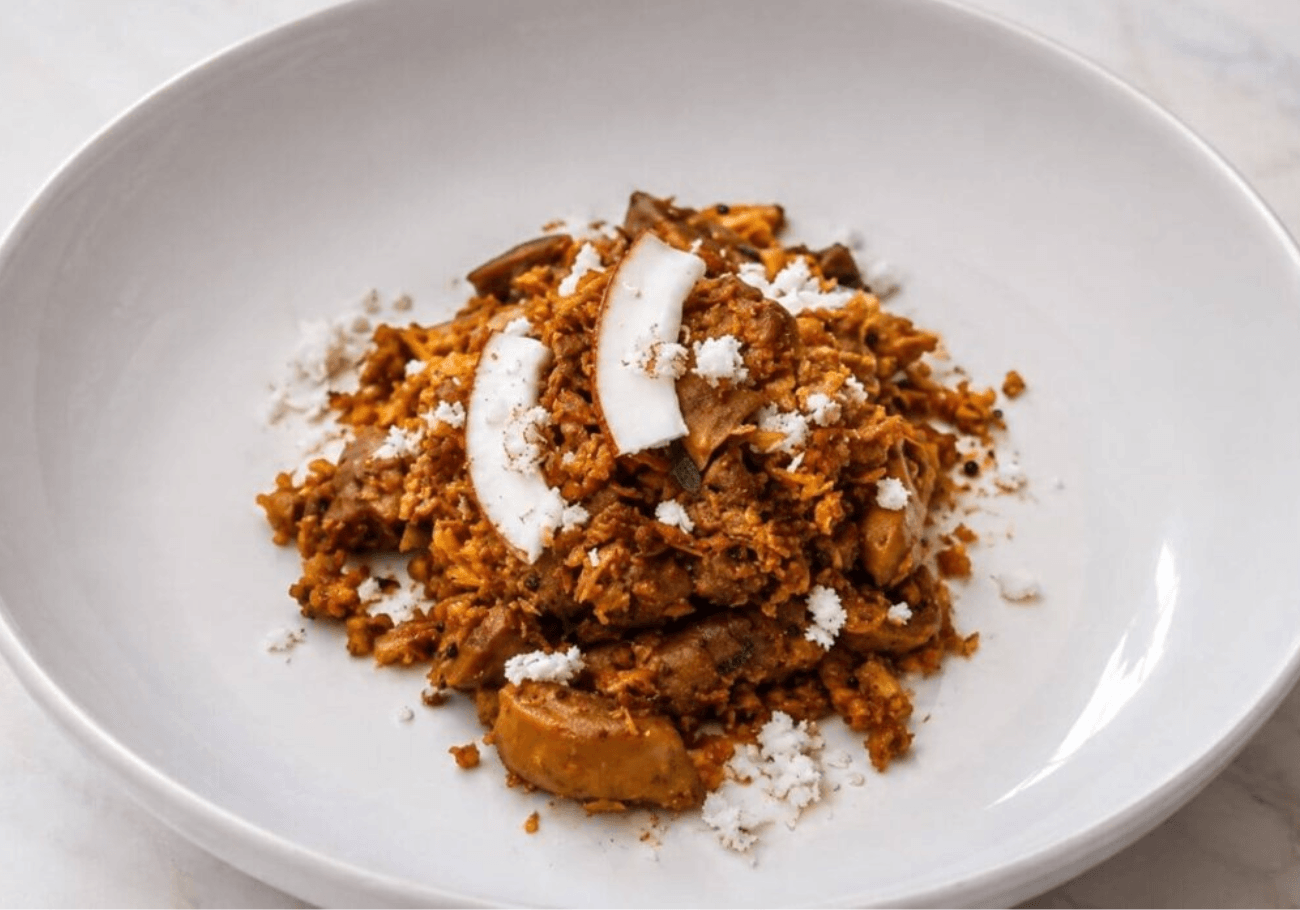 Kerala chicken gizzard thoran with grated coconut and fresh coconut slices