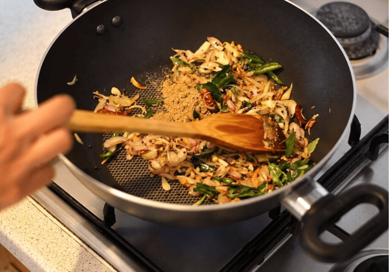 Kerala tempering with onion curry leaves green chilli and spices for chicken gizzard thoran