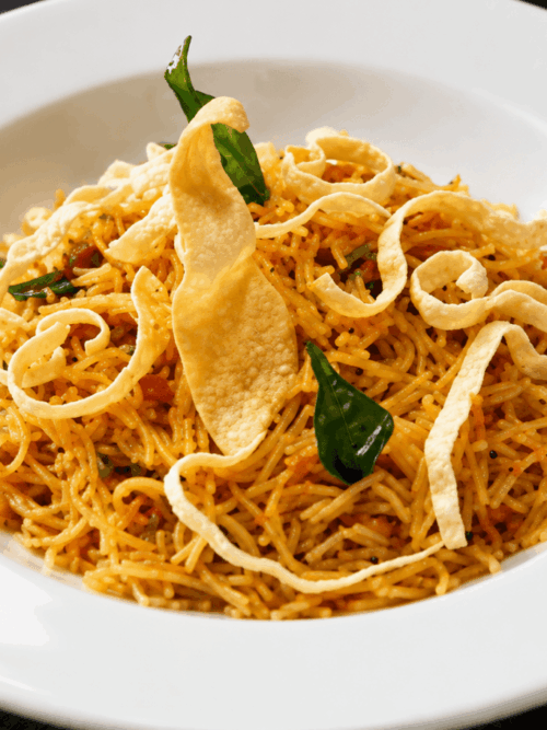 South Indian vermicelli upma with crispy papad and curry leaves