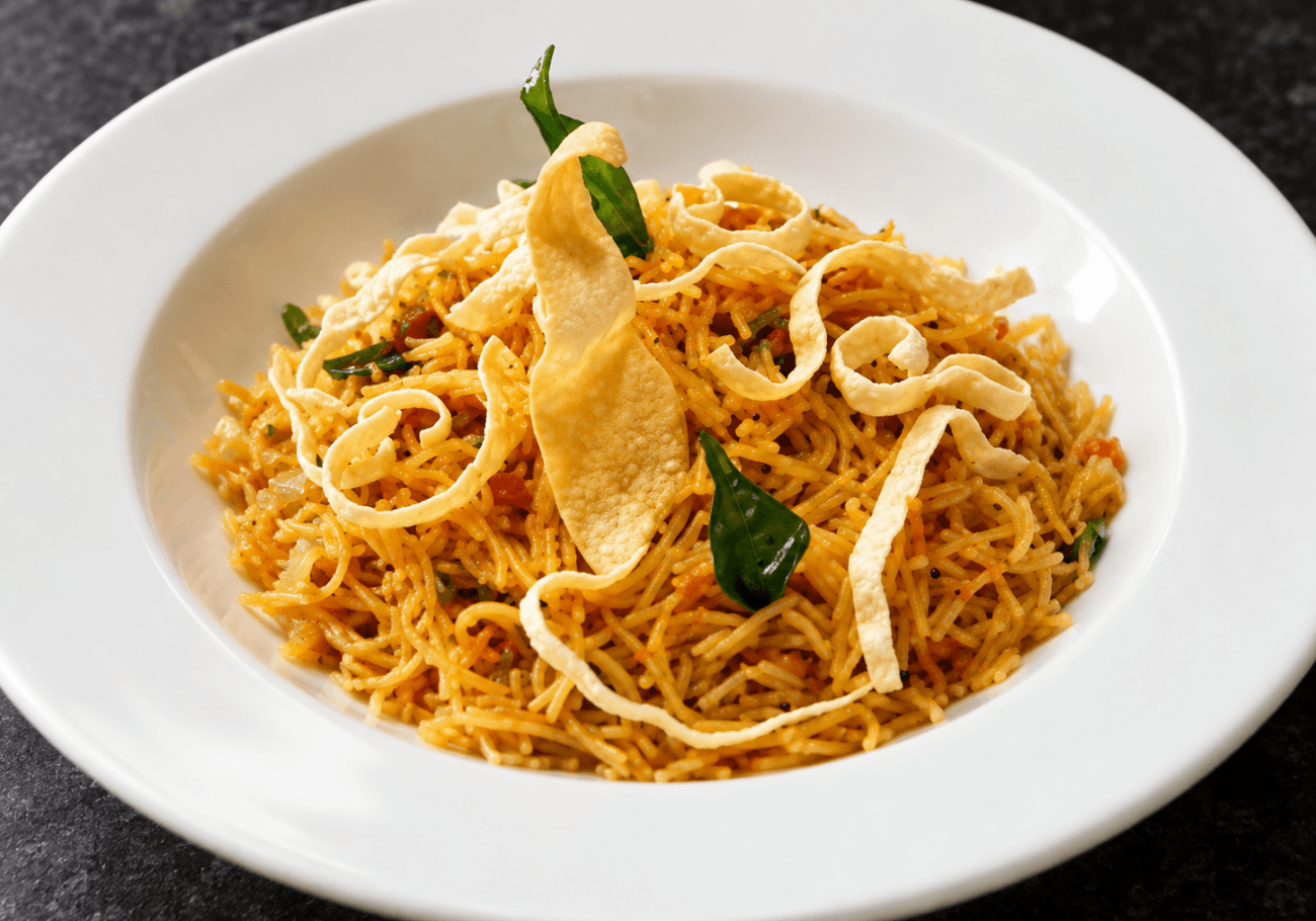South Indian vermicelli upma with crispy papad and curry leaves