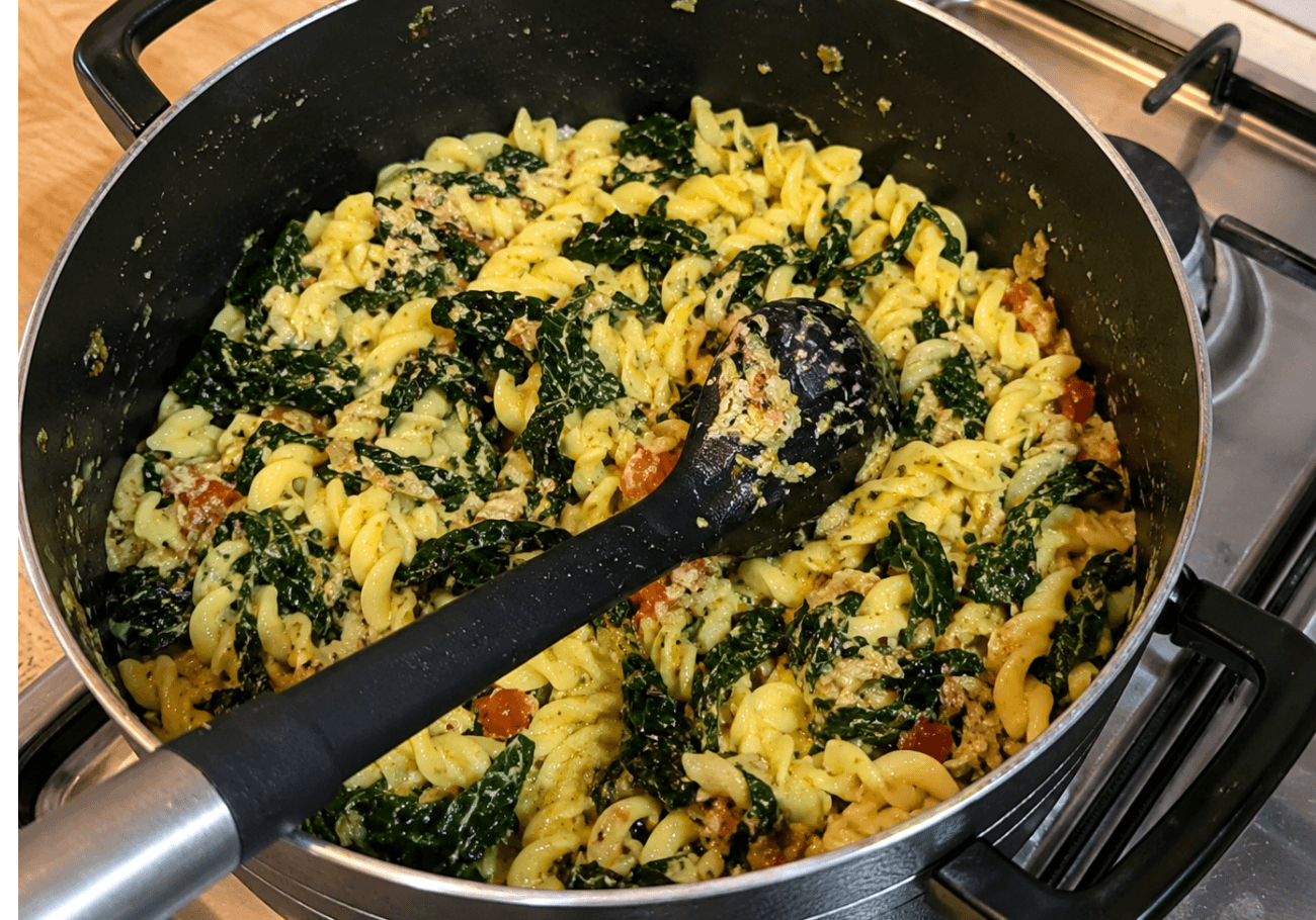 Gluten free fusilli pasta with crab and Cavolo Nero cooking in pan