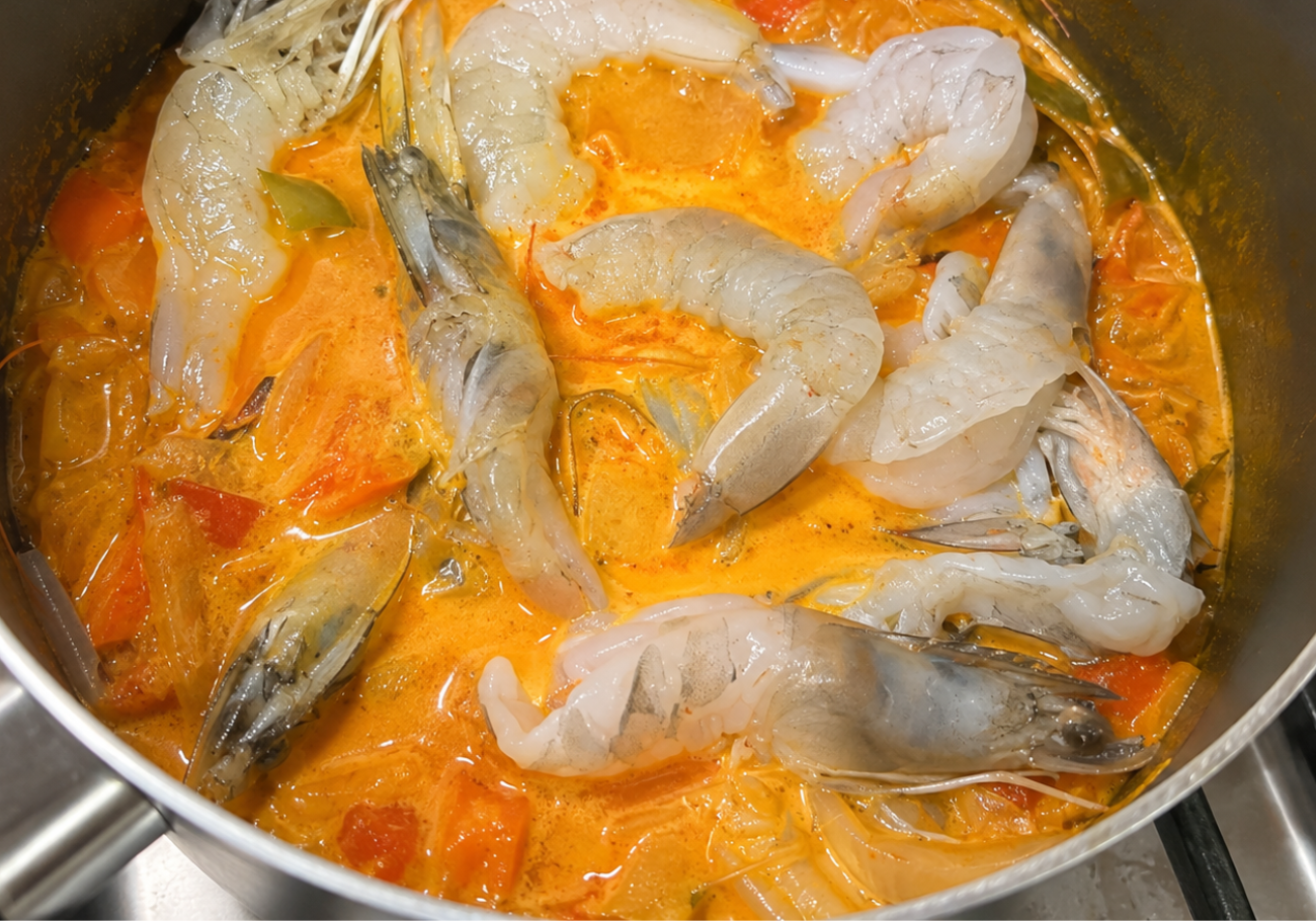 Prawns simmering in coconut milk prawn curry with tomato and spices